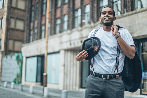 One man, Handsome young gentleman standing on the street downtown in city.