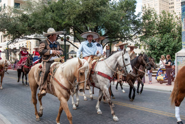 Oaxaca, Mexico - July 09, 2023: Mexican Cowboys riding beautiful horses at the parade in city street, Oaxaca, Mexico