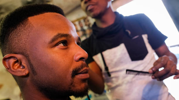 istock Visiting the local township barber 1022012746