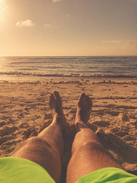 istock Man lying and enjoying on a sandy tropical beach. 1022022036