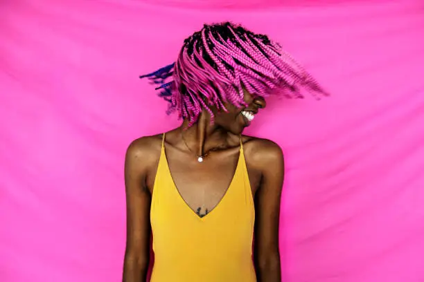Photo of Girl shaking her pink braided hair
