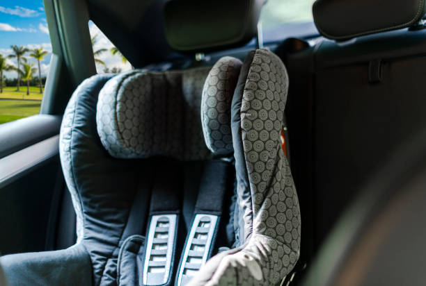 Child safety seat in the back of the car. Baby car seat for safety. Car interior. Car detailing stock photo