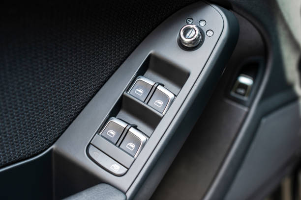 istock Door handle with Power window control buttons of a passenger car. Black leather car interior. Car interior details. Car detailing 1022030196