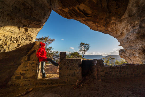 istock Woman looking out from a cave to mountain valley views 1022038554