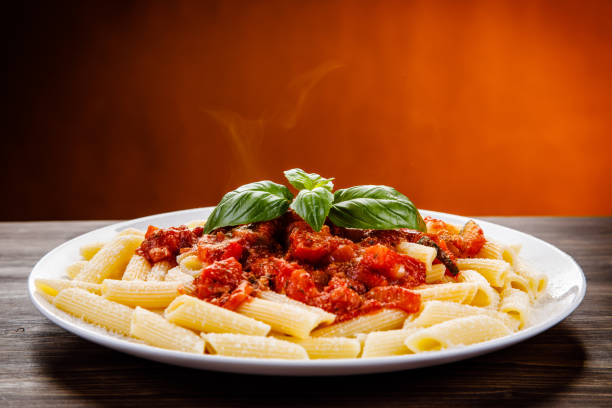 penne mit tomatensauce und schweinefleisch - basil bowl cooked cheese stock-fotos und bilder