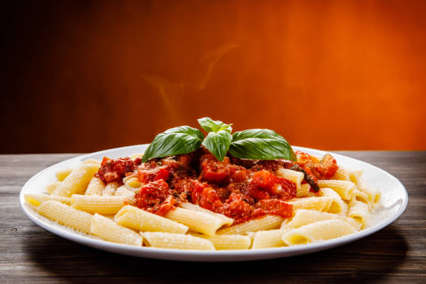 penne with tomato sauce and pork - basil bowl cooked cheese imagens e fotografias de stock