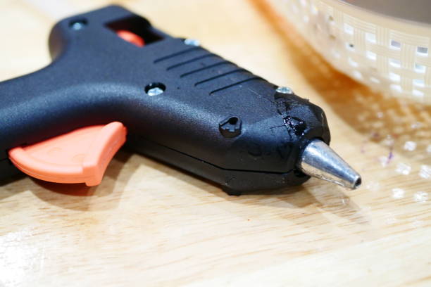 work tools: glue gun - handgun gun blue black imagens e fotografias de stock