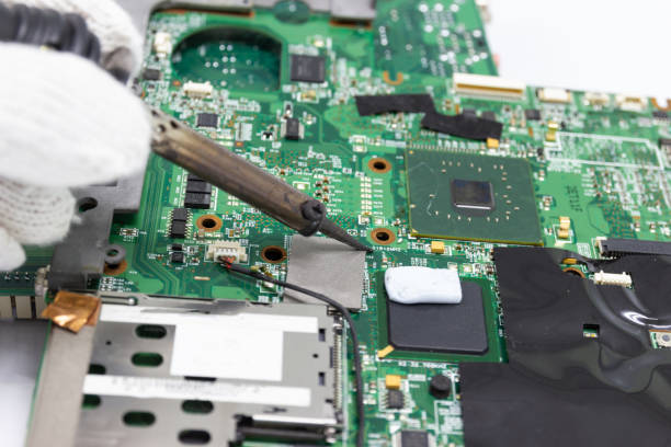 istock technician repairing electronic of the computer's circuit board by soldering Irons. 1022053108