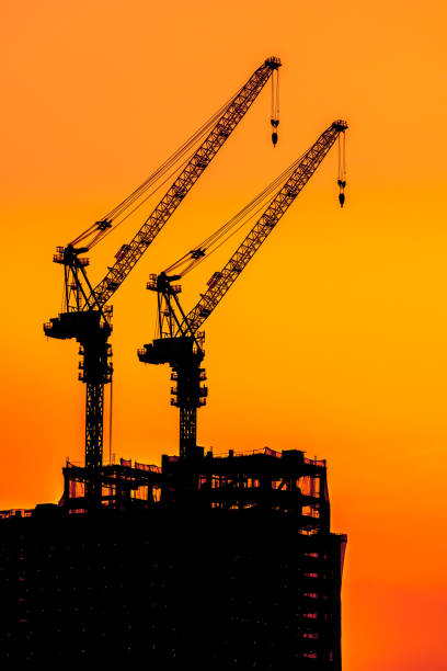 istock Beautiful Silhouette crane under construction building 1022059524