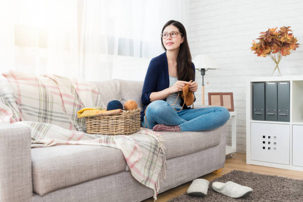 istock woman sitting on sofa looking outside 1022060010