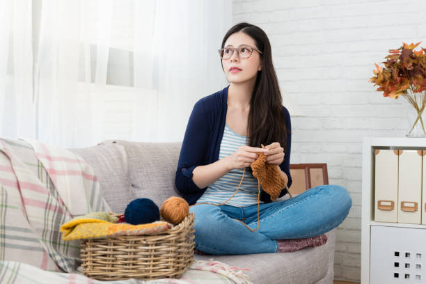 istock charming Asian woman sitting on the sofa 1022060066