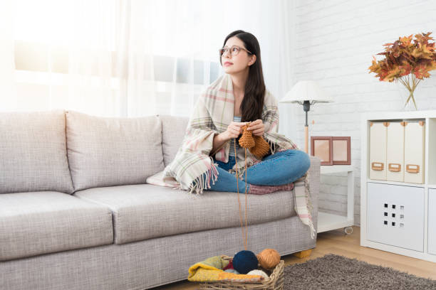 asian woman keeping warm with blanket