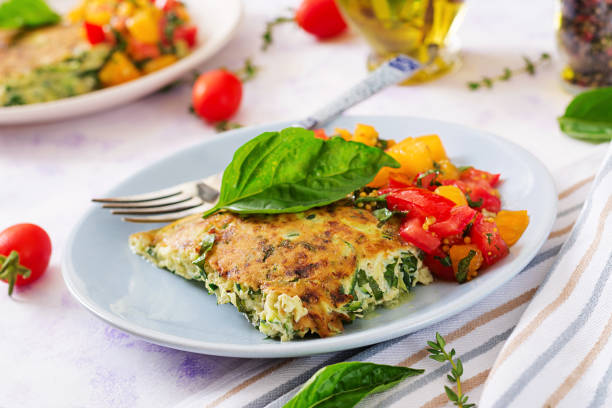 istock Frittata with zucchini, cheese, basil and salsa from tomatoes. Useful breakfast. Italian omelette. 1022060410