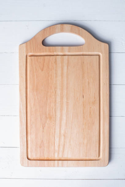 istock Chopping board on white wooden background 1022061238