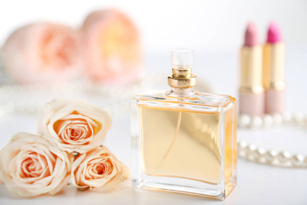 istock Perfume bottle with roses on white background 1022063320