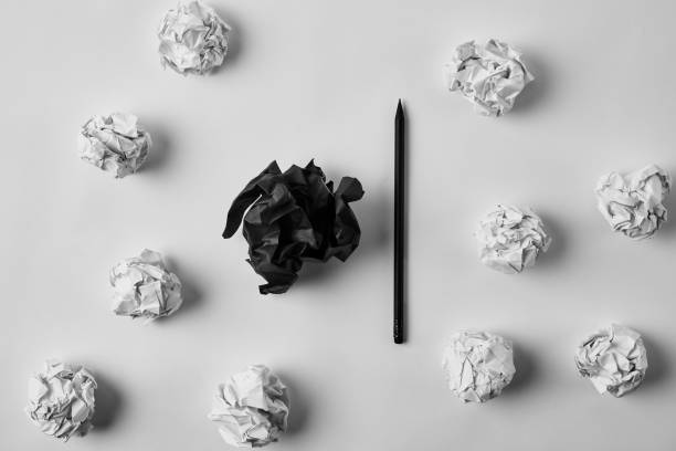 istock top view of crumpled black and white papers with pencil on white surface 1022065654