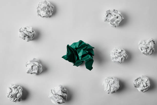 istock top view of green and white crumpled papers on white surface 1022065658