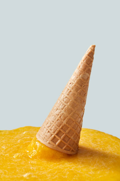istock Fallen waffle cone with yellow ice cream on a gray background with copy space. 1022066186