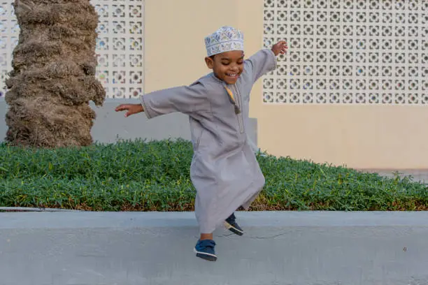 Small Omani boy smiling and enjoying his time in the park