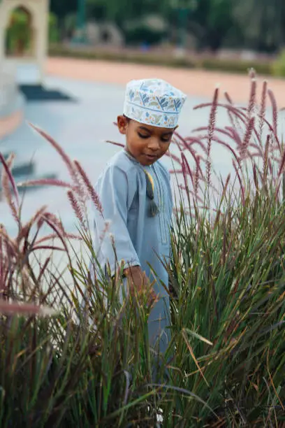 Small Omani boy smiling and enjoying his time in the park