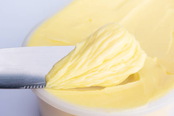 Cheese butter or margarine with knife Cheese butter or margarine with knife margarine stock pictures, royalty-free photos & images