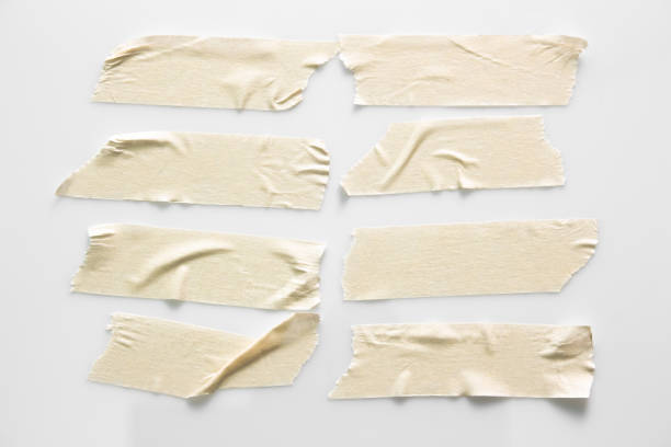istock Set of white scotch tapes on gray background. Torn horizontal and different size white sticky tape, adhesive pieces. 1022081100