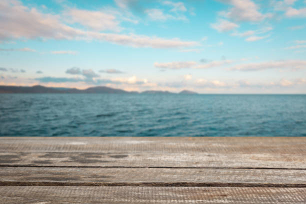 istock Wooden table top on blue sea 1022081592