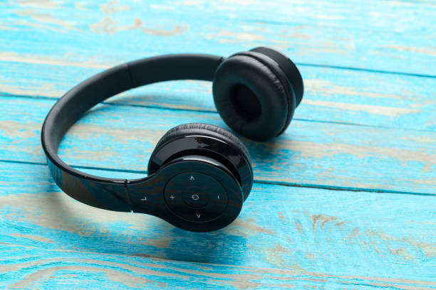 istock Stereo headphones on wooden background 1022085208