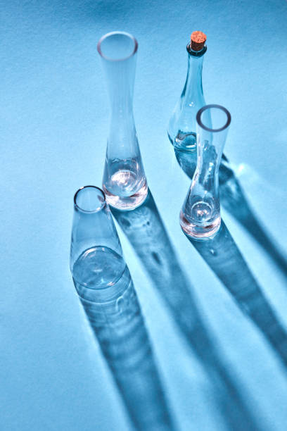 istock Glass vases empty with shadows and reflection on the surface on a blue background. 1022099578