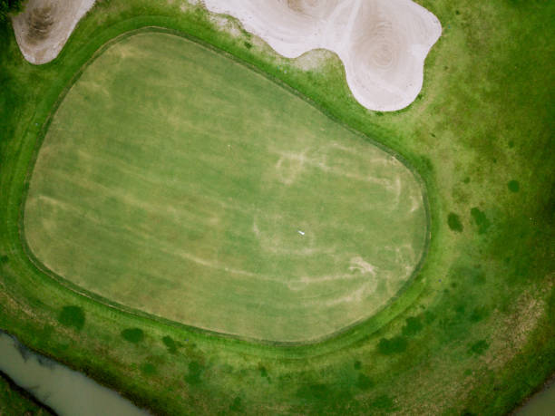 istock aerial view of golf hole with flag in golf course. 1022101928