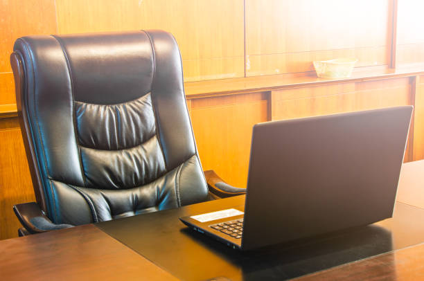 chair empty and computer notebook workplace in office chair empty and computer notebook workplace in office, Office for boss with sun illumination,select focus at boss chair. chairperson stock pictures, royalty-free photos & images