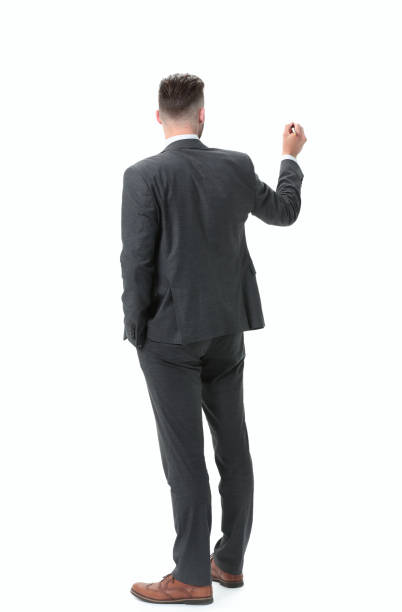 istock rear view.businessman writing on a virtual chalkboard 1022103092