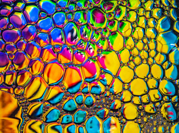 Abstract background, soap foam on the water surface. Beautiful and colorful macro