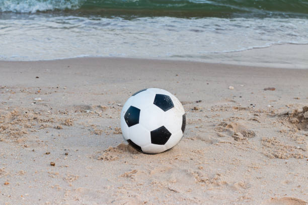 istock Soccer ball on the sand 1022109412