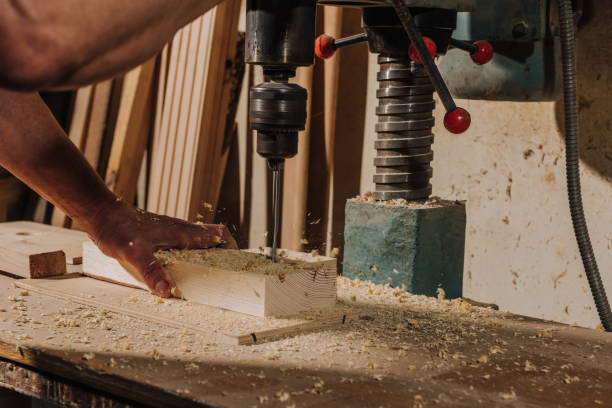 istock partial view of woodworker using electric drill on wood at workshop 1022109940