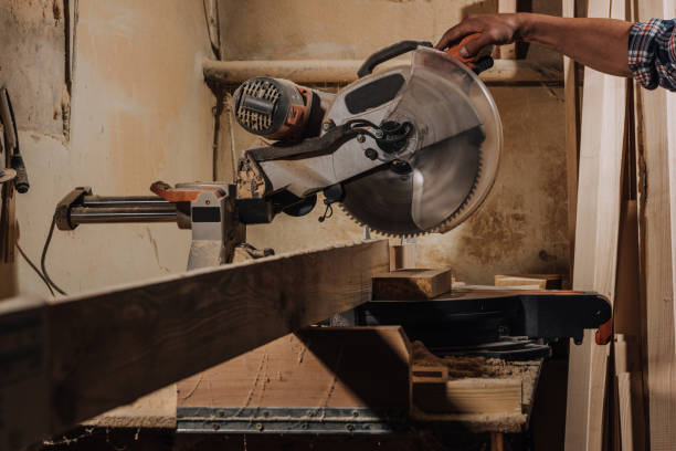 istock partial view of carpenter using circular saw at wooden workshop 1022109966