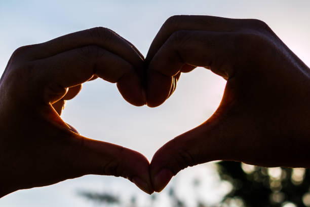 istock love shape hand silhouette at sunset 1022109976