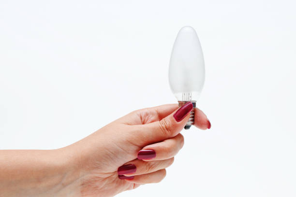 istock Modern electric light bulb in hand on a white background 1022110286