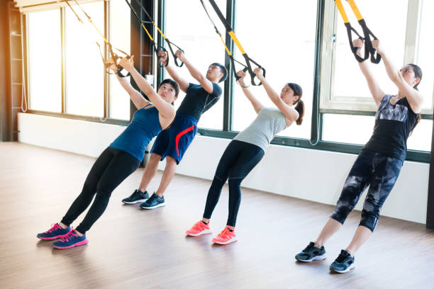 istock team of Asian people training with TRX 1022112950