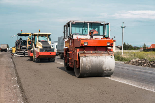 istock Orange Heavy Vibration roller compactor at asphalt pavement works for road repairing. Working on the new road construction site. Repairing. 1022118618
