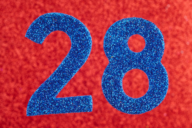 istock Number twenty-eight blue color over a red background. Anniversary. Horizontal 1022118624