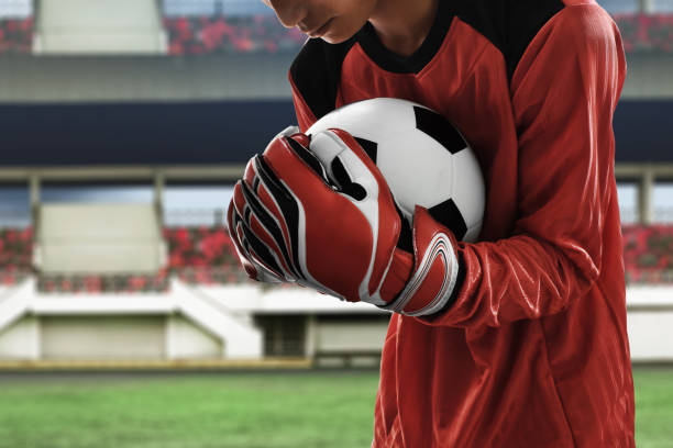 istock Soccer goalkeeper catches the ball 1022121618