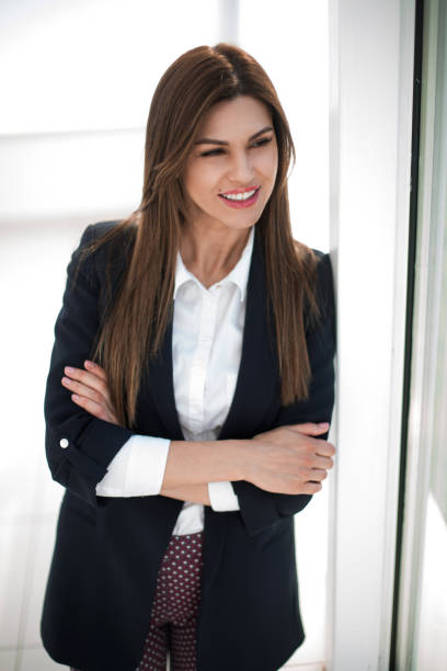 istock close up.serious business woman looking through office window 1022121908