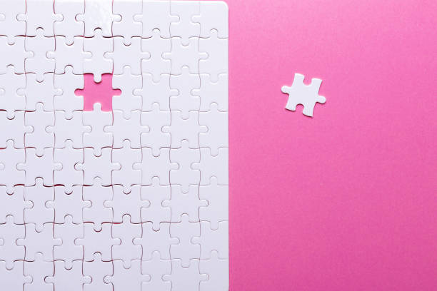 istock White puzzle on pink background. Top view 1022127468