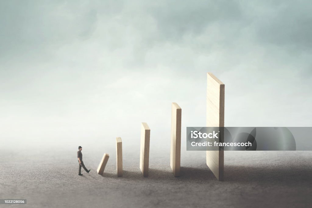 business man kick the first domino piece Small Stock Photo