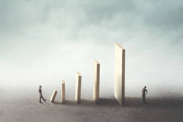 istock pushing domino to kill the rival 1022128104