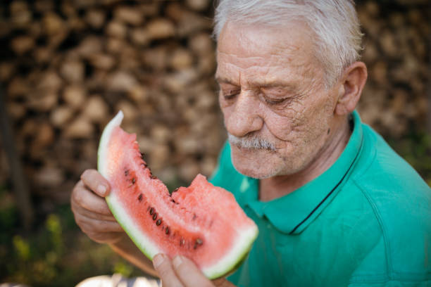 istock Senior man eating watermelon 1022130348
