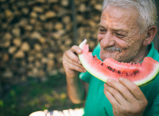 istock Senior man eating watermelon 1022133756