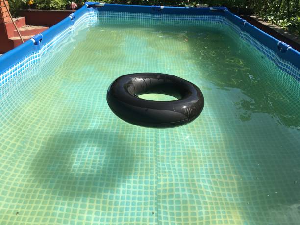 istock Black car wheel in pool 1022133918