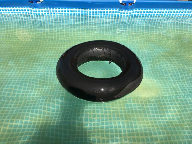 istock Black car wheel in pool 1022133940